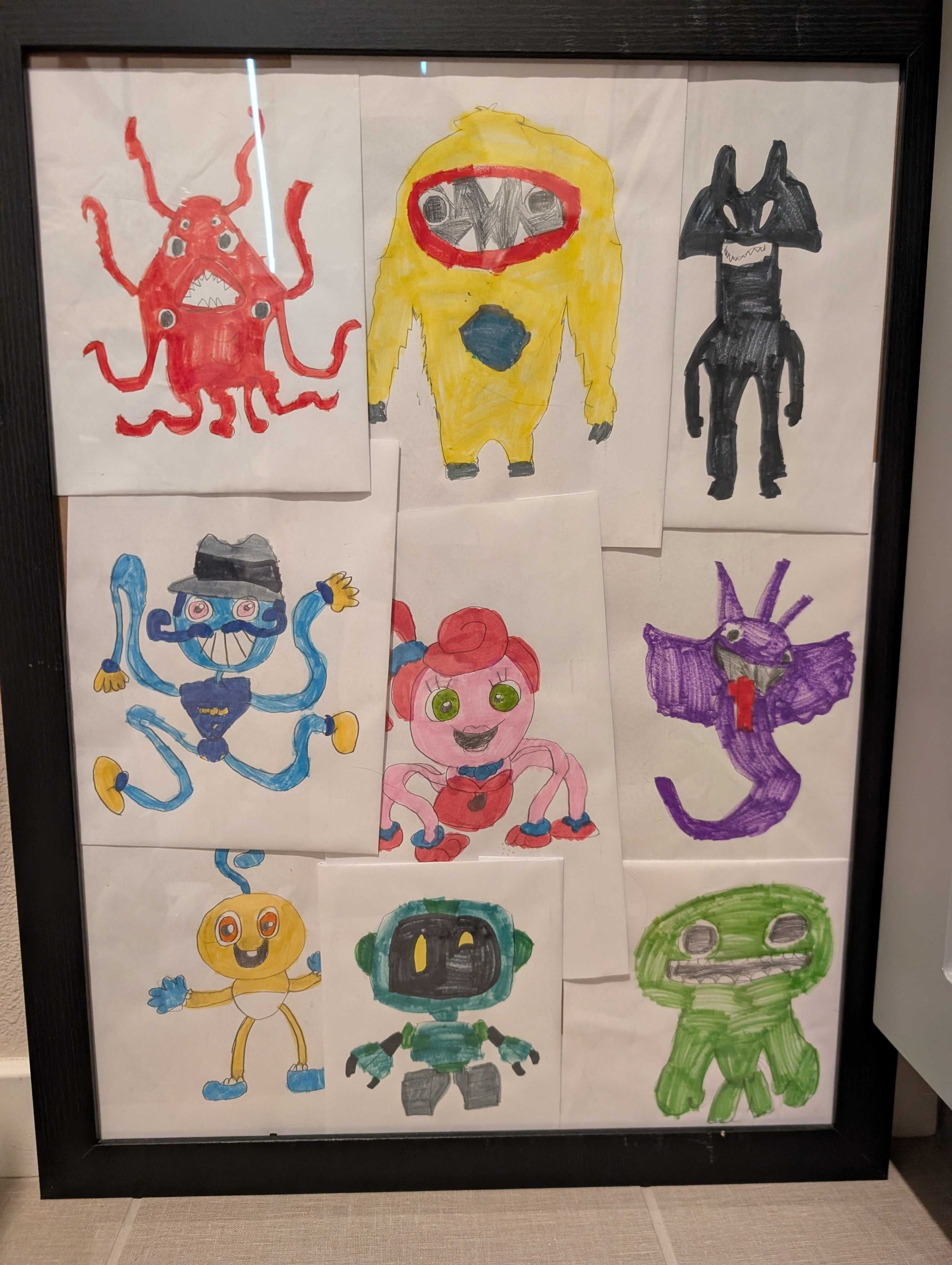 Framed collage of Weston's nine original monster drawings